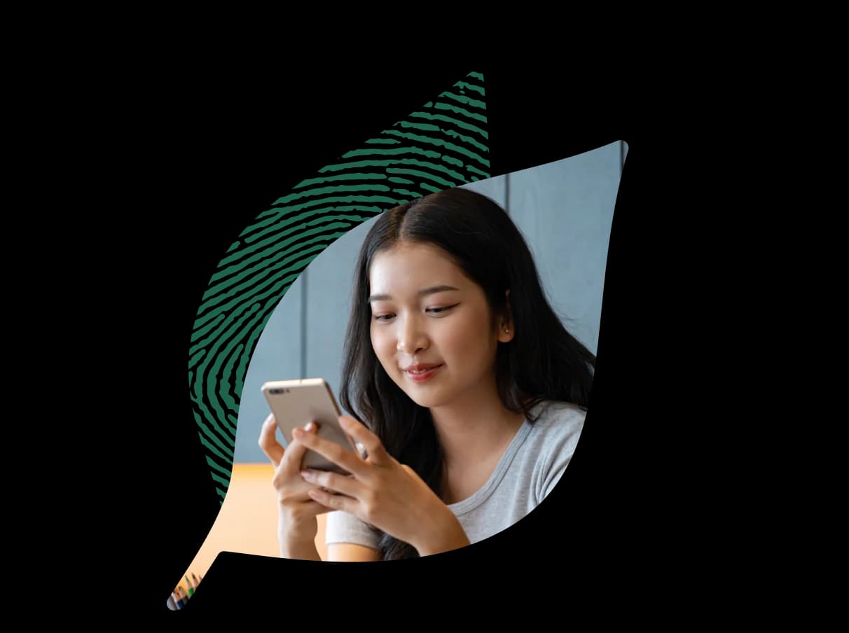 A person looking at their results on a phone, inside the fingerprint leaf
